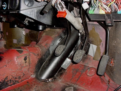 This is a provision to move the exhaust pipes from going under the front cross member and getting flatted all the time to being next to the firewall to prevent that and have a 45 instead of a 90 bend