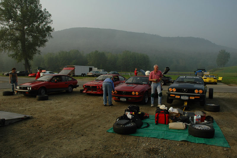 This is the NYC track day gang... Tariks car is on the left, next Gusippe's (our Mechanic), mine with David Rivkin helping me tape up the lights (David just got a GTV6 in addition to his GTA) and Griff's, not Griffs knee pads...